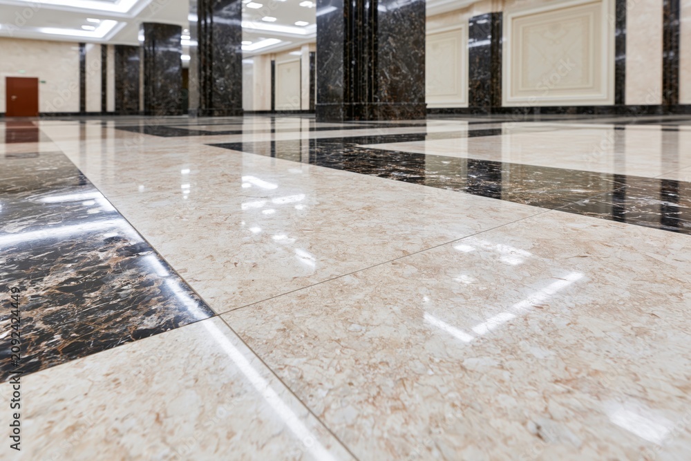 Obraz premium The Marble Lobby Floor: Gleaming Tile Hallway with Columns and Reflections