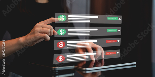 Person interacts with digital financial interface displaying stock market data on tablet