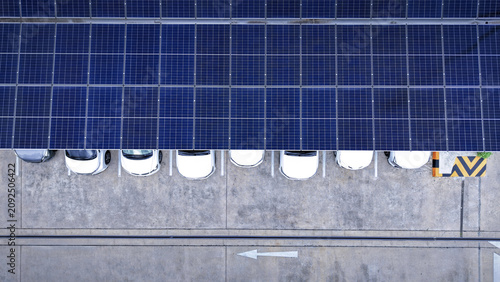 Solar roof. Aerial drone view of solar roof of carport or carpark. Photovoltaic panels covering a parking lot. Clean renewable energy infrastructure supports sustainable transportation. Solar energy