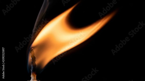 Single Candle Glowing Softly in Darkness