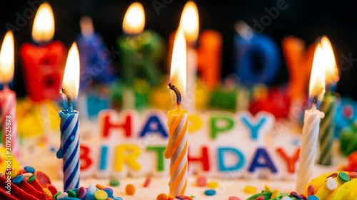 Birthday Candles Burning on Cake Close Up