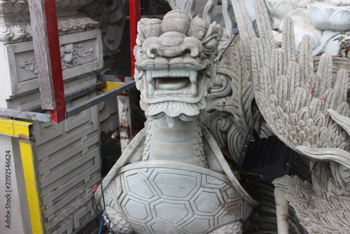 Bild auf Leinwand Stone dragon turtle statue featuring intricate craftsmanship in outdoor temple area