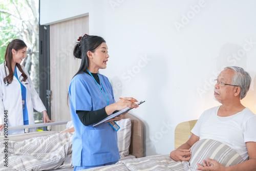 фотографія Senior care scene: Elderly Asian friends gather to chat and laugh together near
