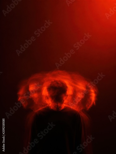 Abstract multiple exposure portrait of anonymous man with motion blur trail, intense saturated crimson neon lighting for psychological storytelling and conceptual mental health branding