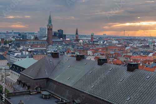 Copenhagen Denmark - August 12 2025. Red rooftops and copper spires fill the Copenhagen skyline beneath a clear blue summer sky in soft morning light.