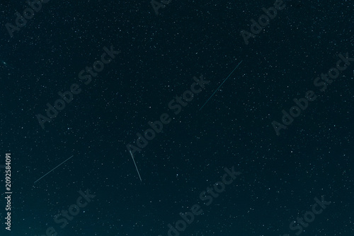 Photos A stunning wide shot of a deep midnight blue sky scattered with countless bright white sparkling stars during a clear night in outer space