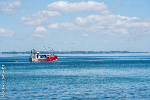 Photography Red Fishing Boat Navigating in Open Sea Seen From Sandy Beach at Baltic Sea