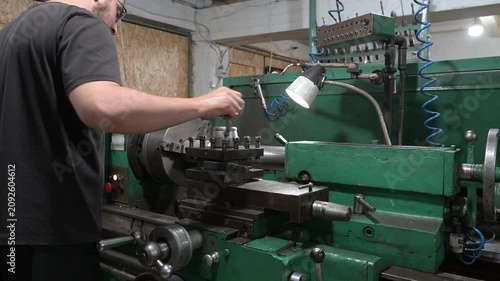 A lathe is installed in the production workshop. An electric lathe removes a layer from a metal workpiece, shaping it into a finished product. Production of metal products.