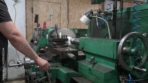 A lathe is installed in the production workshop. An electric lathe removes a layer of metal from a workpiece, shaping it into a finished product. Production of metal products.