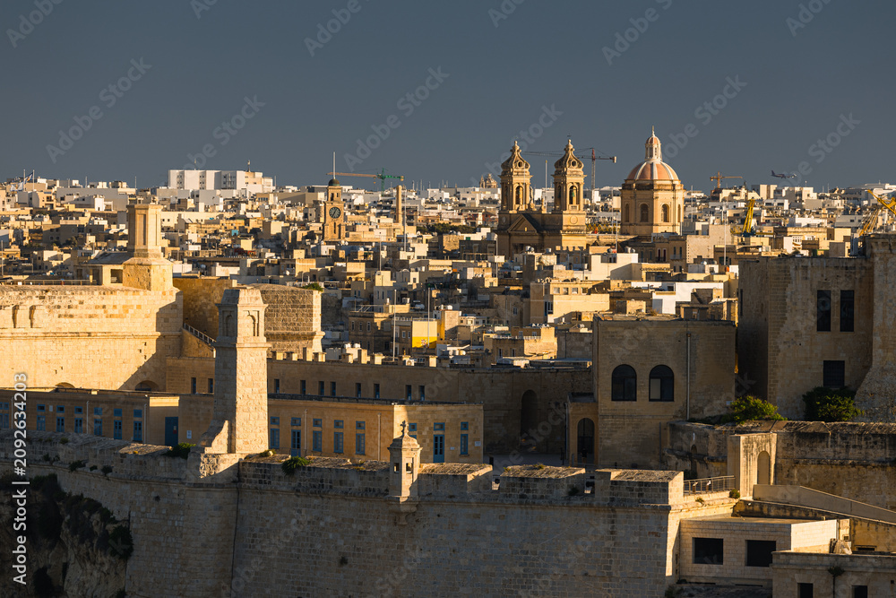 Fototapeta premium Charming historic streets and majestic architecture of Birgu (Vittoriosa), Malta. Admire the warm limestone facades, medieval defensive walls, and stunning waterfront marina views.
