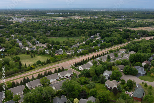 Road Cuts Through Suburban Neighborhood Summer