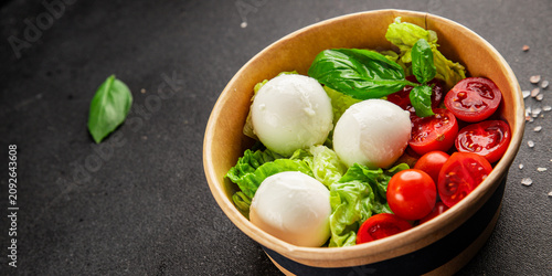 Mini buratta salad buratta cheese tomato, green leaf lettuce, mozzarella lunch or dinner tasty organic snack fresh delicious gourmet food background on the table rustic food top view copy space 