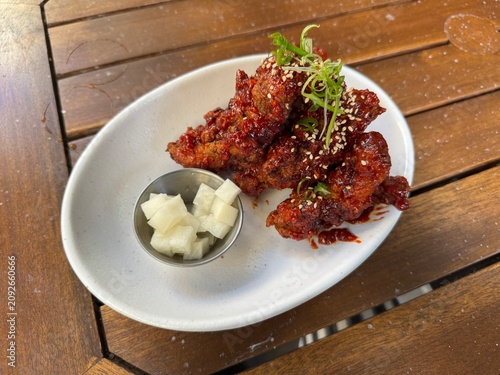 Konstfotografi Freshly served Korean fried chicken with spicy glaze and pickled radish appetize