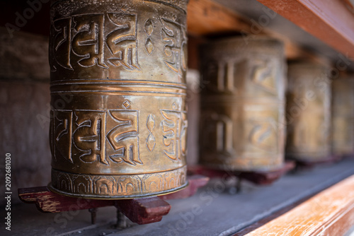 Obraz na płótnie Detail of brass Buddhist prayer wheels at a temple in Ladakh