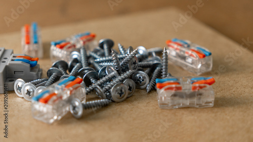 Fastening and electrical installation accessories. Automatic clamps for electrical wires, self-tapping screws, screws