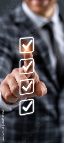 Business professional using digital checklist interface with checkmark icons, representing task completion, quality control, workflow management, and process verification