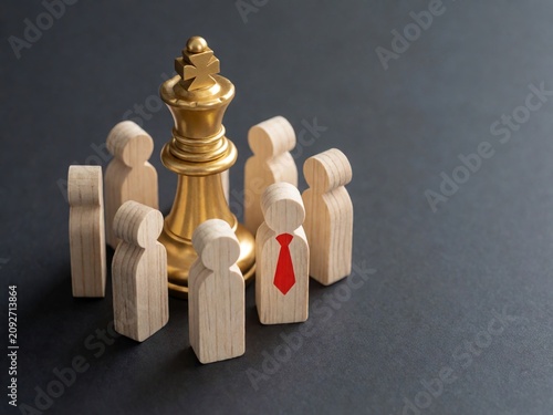 Golden Chess King Surrounded by Wooden People