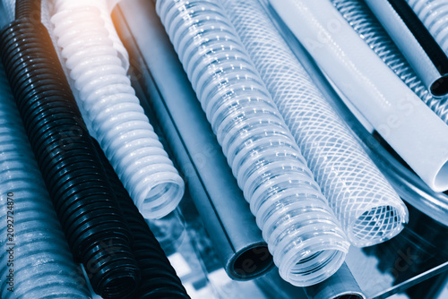 Tablou pe pânză Flexible hoses and tubes displayed on glass shelves