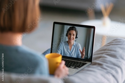 Woman on laptop in remote video conference meeting for online work communication