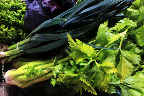Fresh organic green vegetables background. Top view of raw leek, celery, lettuce and chard at local farmers market.