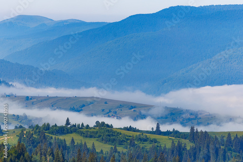 Misty morning in the Carpathian mountains with thick fog in the valley.