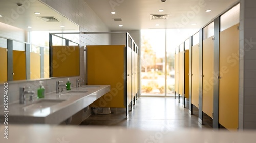 Modern Public Restroom Interior with Yellow Stalls
