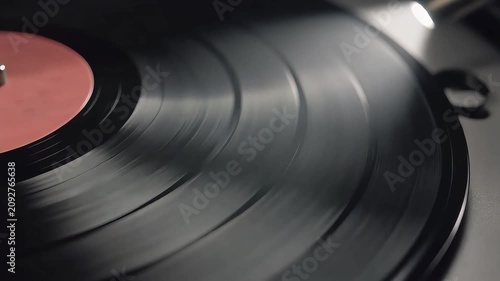 Spinning vinyl record close up with pink label
