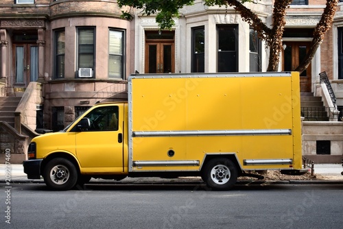 yellow truck parked on the street