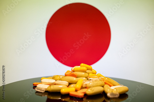 Close up of assorted pills with Japanese flag background.