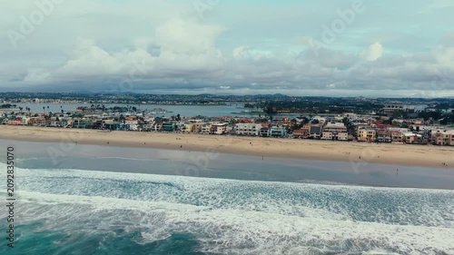 Drone aerial view of Mission Beach coastline with sandy shoreline and Pacific Ocean in San Diego California landscape