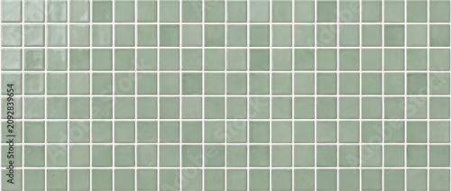 Sage green ceramic mosaic texture featuring seamless glossy square tiles in a clean minimalist pattern for elegant interior backgrounds