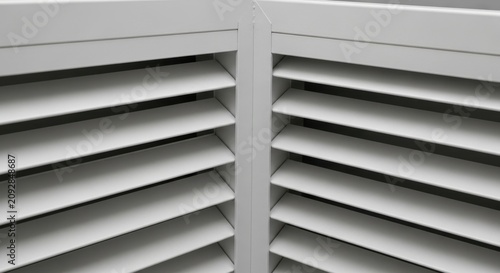 Close up view of white wooden window shutters.