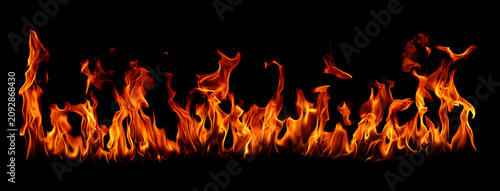 Canvas Print Realistic blazing fire flames isolated on black background with intense heat, burning energy, orange flame texture, and dramatic fire effect
