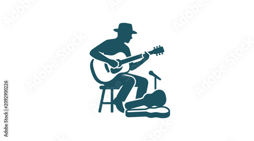 Fotografie Man playing acoustic guitar sitting down.