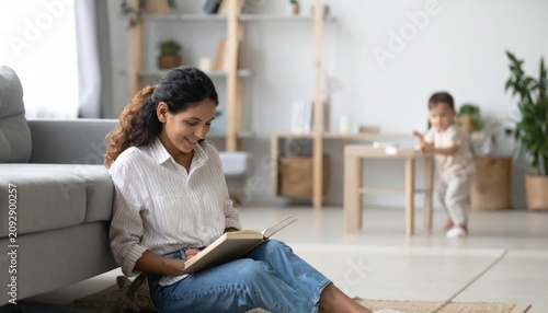 Woman reading book on couch indoors.