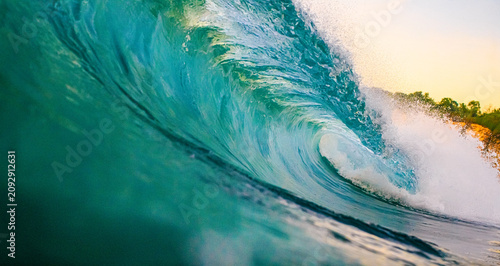 Powerful Turquoise Ocean Wave Curling with Golden Sunset Light