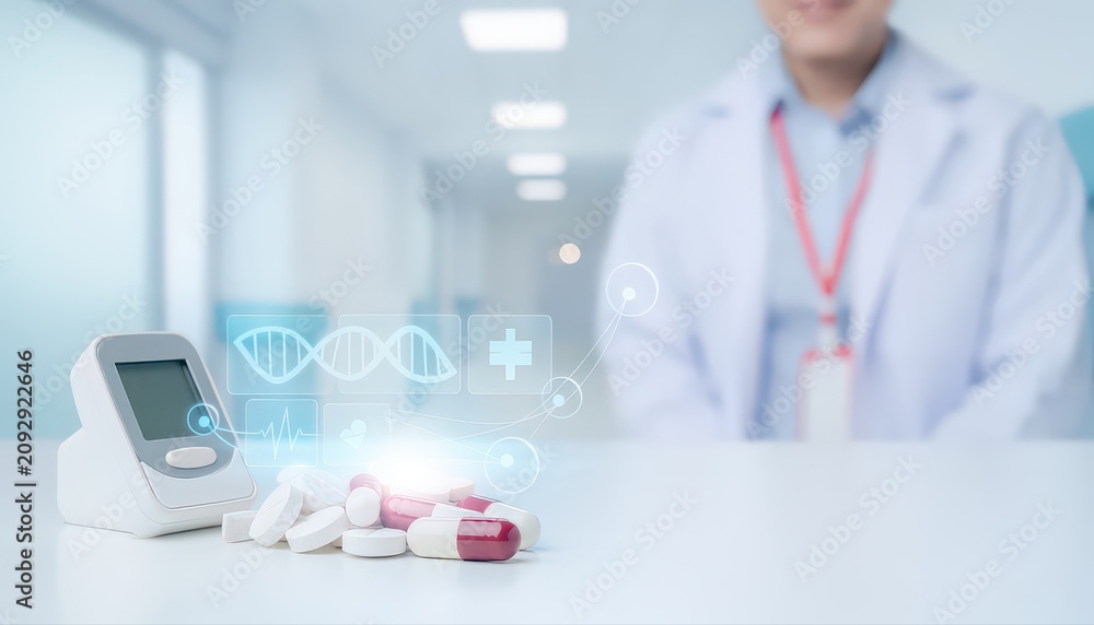 Fototapeta premium Futuristic medical pills with a digital holographic device on a table with doctor on the background.