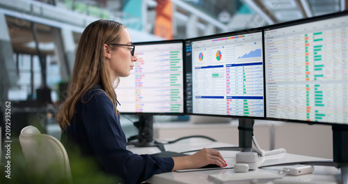 Bild auf Leinwand Young Woman In Medical Office Analyzing Billing Data