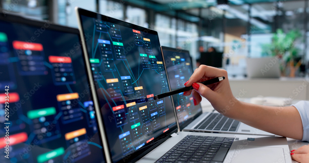 Naklejka premium Young Business Analyst Studies Automated Workflow