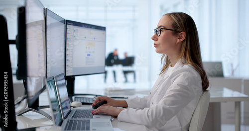 Obraz na plátne Woman Reviewing Medical Billing Claims On Laptop