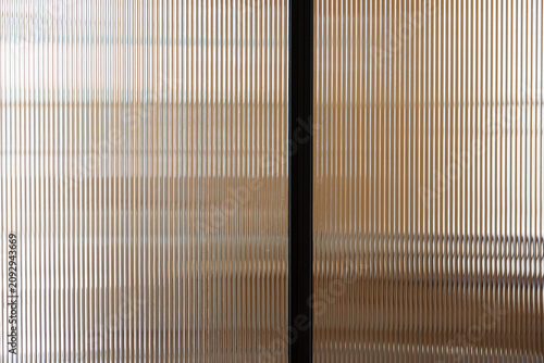 clear polycarbonate plastic background and texture. Transparent material Corrugated plastic surface use for partition wall, door or roofing. close up picture.