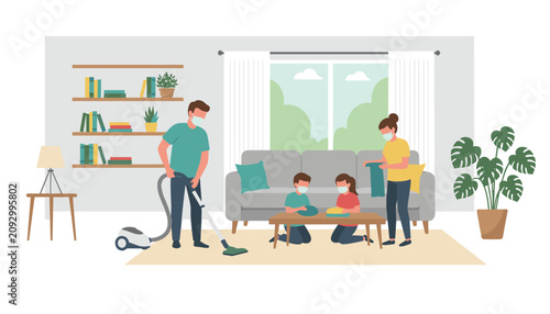 Family wearing face masks doing household chores together, vacuuming, dusting, and folding clothes in living room.