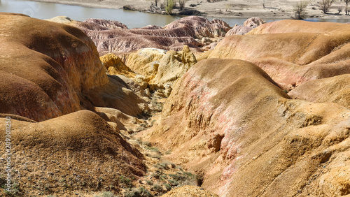 Fotografía Unique colorful Yardang landform of the Five Color Beach along the Irtysh River under a blue sky, Xinjiang