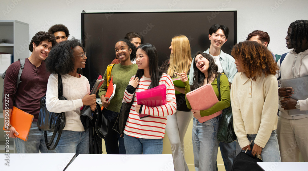 Fototapeta premium Group of multiethnic young adults smiling and talking in a modern college classroom