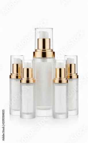 Elegant display of white and gold cosmetic pump bottles for skincare and beauty routines, highlighting minimalist design and essential personal care products