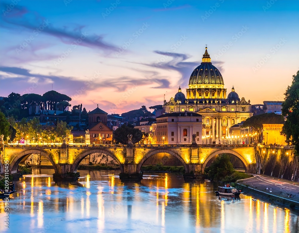 Fototapeta premium Illuminated cityscape at dusk, featuring domed church and arched bridge
