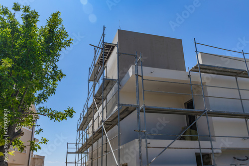 Modern Apartment Building Under Construction in Croatia with Scaffolding