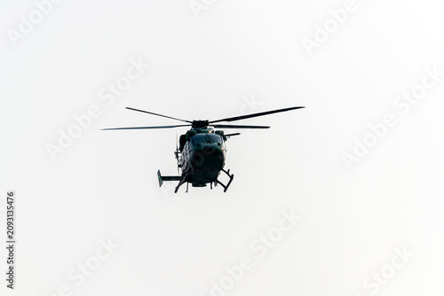 Helicopter is flying on isolated white background