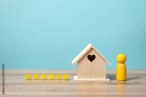 Home Rating and Customer Satisfaction Concept With Wooden House and Five Stars