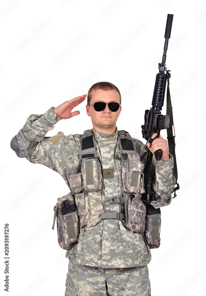 Fototapeta premium Soldier saluting while holding a rifle.